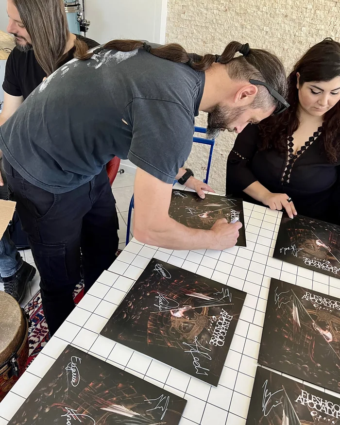 Fleshgod Apocalypse signing vinyl sleeves at Studio 86